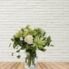 Green and white bouquet in a clear glass vase