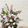 Large bouquet of white lilies, pink roses, and purple flowers