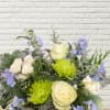 Bouquet of white roses, green spider mums, and blue flowers