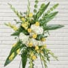Tall floral standing spray with yellow roses and white hydrangeas