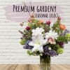 Mixed bouquet of white, pink, purple, and orange flowers in a glass vase