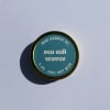 Round candle tin labeled "sea salt waves"