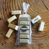 Wrapped candy bars and gold foil chocolates arranged around a clear gift bag