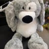 Gray and white plush dog toy with floppy ears and a black nose