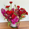 Red and magenta mixed bouquet in a glass vase