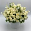 White roses and calla lilies in a white hatbox