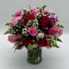 Bouquet of pink and red roses in a clear glass vase