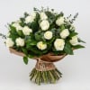 Bouquet of white roses with eucalyptus and brown paper wrap