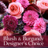 Blush and burgundy floral arrangement with roses and dahlias