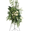Tall white rose and greenery standing spray on an easel