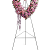 Pink rose funeral wreath on a standing easel with ribbon