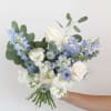 Handheld bouquet of white and pale blue flowers with eucalyptus