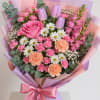 A large pink rose takes center stage in this Pink Charm flower