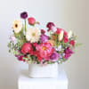 Colorful mixed bouquet in a white ribbed vase