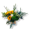 Sunflowers and white roses in a glass vase with greenery