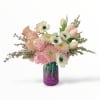Pink and white bouquet in a purple glass vase