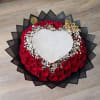Heart-shaped bouquet of red roses with white baby's breath and black wrapping