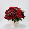 Red rose bouquet in a cream pedestal vase