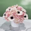 Pink and white floral arrangement in a white vase