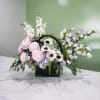 Pastel floral arrangement in a glass vase with pink, white, and lavender blooms