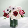 This pretty mix of pink anemones, red roses, and fluffy white hydrangeas