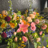 Large mixed bouquet with pink lilies, roses, and blue flowers