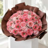 Bouquet of pink ranunculus wrapped in brown paper