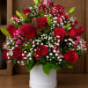 Red roses and lilies arranged in a white hatbox