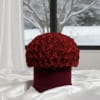 Red rose dome in a burgundy box on white satin