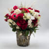 Red and white rose bouquet in a rustic twig vase