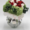 Bouquet of red and white roses with green hydrangeas in a glass vase