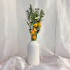 Tall bouquet of yellow and white roses in a white vase
