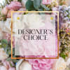Pink and white floral arrangement with a designer's choice label