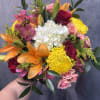 A lively, colorful celebration of roses, lilies, and hydrangeas &mdash; perfect for