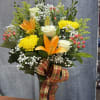 A joyful mix of orange lilies, bright yellow mums, lush hydrangeas, and