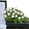 White Carnation casket spray with assorted foliage.