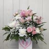 Pink and white floral arrangement in a white box with a pink footprint design