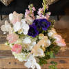 Bouquet of white orchids, pink tulips, and purple anemones