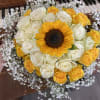 Bouquet of yellow and white roses with a sunflower center
