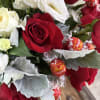 Bouquet of red and white roses with wrapped chocolates