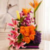 This arrangement is a bold, modern floral composition that combines vivid color