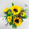 Bouquet of yellow sunflowers in a clear glass vase