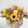 Pink and yellow flower arrangement in a wooden box