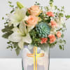 Peach roses and white lilies in a glass vase with a cross design