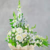 White rose and orchid arrangement with a clear cross centerpiece