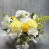 Yellow and white bouquet in a clear glass vase
