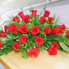 Large arrangement of red roses with greenery on a table