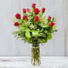 Medium bouquet of red roses with lush greenery in a clear glass vase