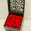 Square black gift box of nine red roses with an open decorative lid