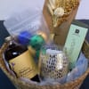 Gift basket with candles, bath soak, and a dried floral bundle